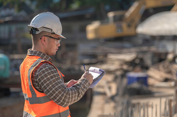 Construction engineer working on a bridge construction site over a river,Civil engineer supervising work,Foreman inspects work at a construction site