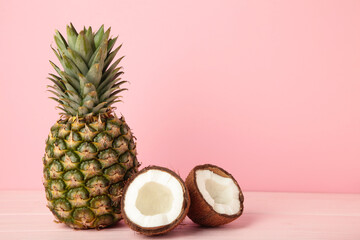 Fototapeta na wymiar Pineapple with coconut on pink background. Tropical fruit