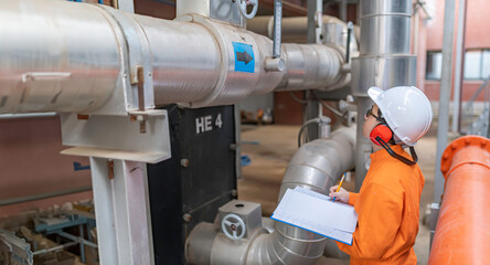 Maintenance technician at a heating plant,Petrochemical workers supervise the operation of gas and oil pipelines in the factory,Engineers put hearing protector At room with many pipes