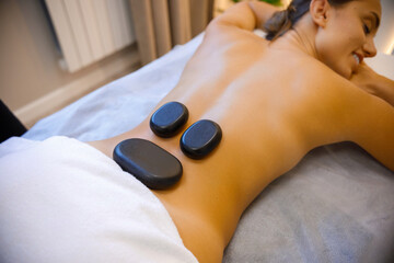 Obraz na płótnie Canvas Soothing Stone Massage: Restoring Balance and Energy
