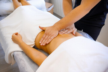 Fototapeta na wymiar Gentle Care: Expert Massage on the Stomach
