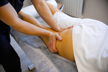 Fototapeta premium Tension Relief: Professional Leg Massage in Action