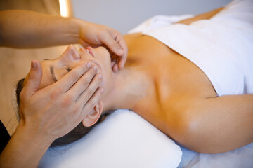 Obraz na płótnie Canvas Ultimate Relaxation: Facial Massage by Professional