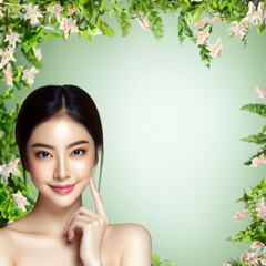 Fototapeta premium Young Asian beauty woman with long curly hair in makeup touches her face and perfect skin on isolated beige background. 