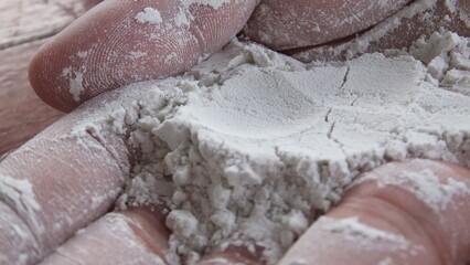Close-up of white tapioca starch on hand