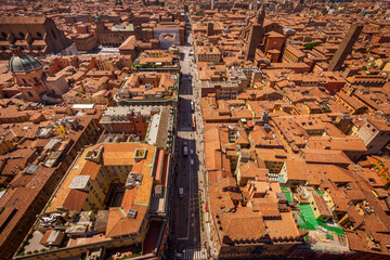 Bologna, Italy, 05.18.2018 - cityscape from Asinelli tower, Two Towers, Due Torri. Buildings, tiled roofs and streets of Bologna. Italian red city.