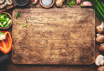 Vegan food and cooking background. Wooden cutting board, vegetables, spices and ingredients for preparing vegetarian Asian dishes with mushrooms and soy sauce. top view, copy space - obrazy, fototapety, plakaty