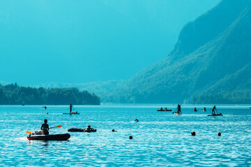 Fototapeta premium People enjoying water activities at lake Bohinj in Slovenia, summer season outdoor sports