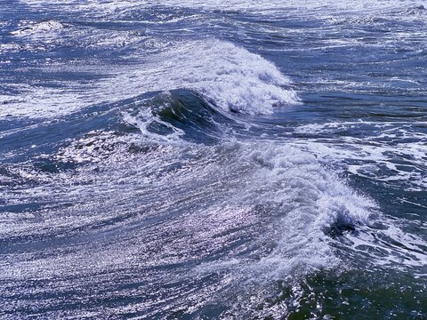 Sea waves in motion, shiny blue stormy ocean surface.