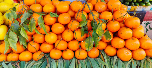Orange fruits background. close up tilt up shot of fresh oranges on display on a farmers market...