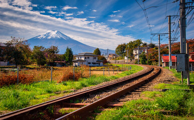 Mt. Fuji with train and rice field at daytime in Fujiyoshida, Japan.