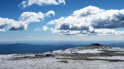 Serra da Estrela Natural Park (Portugal) covered in snow with silhouettes of people in the background