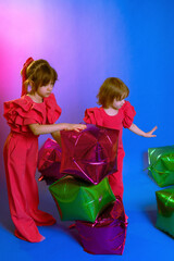 two little girls play, build a tower out of cubes, play with inflatable balls