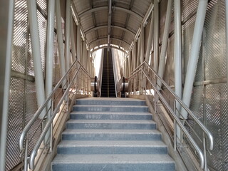 a city subway station crossing stairs, metal stairs, indoor with Stairs, stair way at shopping mall...