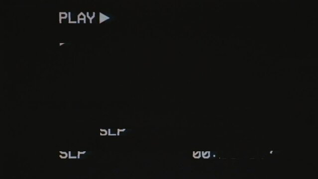 Effect of Glitch TV on black background with text 'PLAY' and timecode. Videocassette recorder. Damaged cassette type.