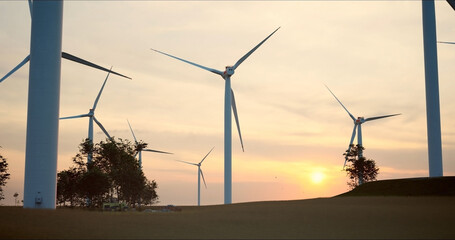 close-up camera moves along the blades of huge wind turbines against low sun. Green and renewable energy concept. - 756645554