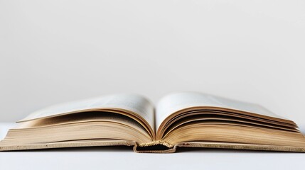 Close-up view of an open book against a pristine white background