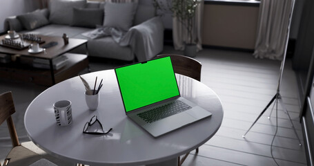 Laptop place on living room table, Green screen display, Close up monitor of notebook with mock up