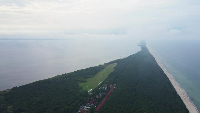 Birds eye view of sea landscape with sandy beach and Jastarnia city on Hel peninsula. Baltic Sea coast in Poland. Resort town in the summer season