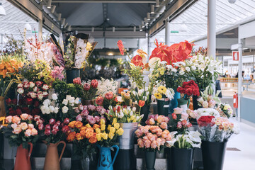 A large display of flowers in a store at the Porto market, Portugal