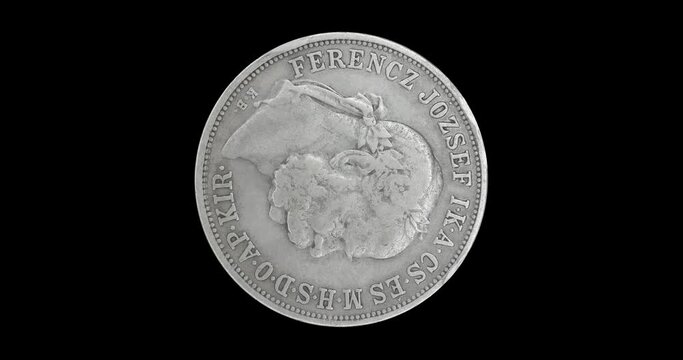 Obverse of old Hungary coin 5 korona 1908, isolated in black background. Loopable animation in 4k resolution video.