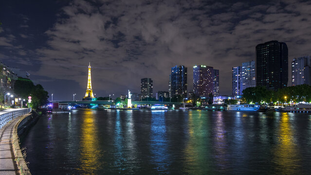 The small Statue of Liberty located near the Eiffel tower night timelapse. Paris, France