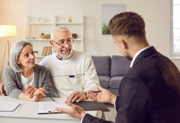 Talks with realtor senior couple property choice of house in retirement and signing contract. Real estate broker helps signing contract property purchase agreement Signing contract to real estate.