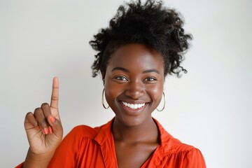 Happy African American woman gesturing upwards with a smile