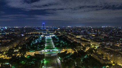 Aerial Night timelapse view of Paris City and Field of Mars shot on the top of Eiffel Tower