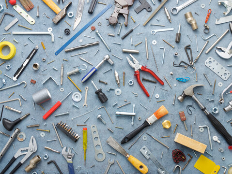 Tools, screws and other metal hardware on a workbench