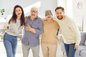 Portrait of happy, cheerful, smiling senior and young family members. Joyful old parents and adult children having fun together. Grown up grandchildren spending time with grandparents