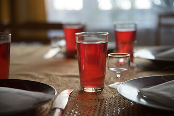 festive table laid with red juice glasses and dishes