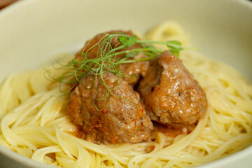A plate of spaghetti pasta with meatballs