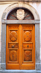 Ancient and magnificent solid wooden door to the town of Bonifacio, a superb town in southern Corsica (nicknamed the island of beauty), famous for its marina, its gigantic cliffs and its citadel