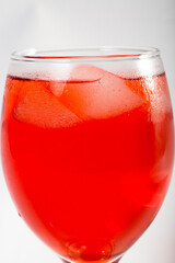 Red colored drink in a glass with ice macro photography as per likes of Rooh Afza and Jam e Shirin