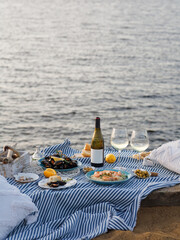 Table full of seafood and vegetable dishes with sea horizone in the background