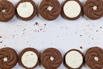 Chocolate cookies with cream filling on a white background with copy space