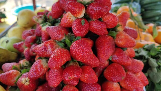 Sweet fresh strawberries. A lot of strawberry closeup view. New spring harvest of ripe red sweet strawberries at pakistani market. Season pick strawberries. Beautiful 4K Footage.