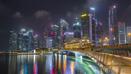 Esplanade bridge and downtown core skyscrapers in the background Singapore night timelapse...