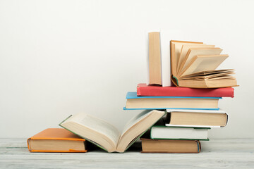 Open book, hardback colorful books on wooden table. Back to school. Copy space for text. Education business concept.
