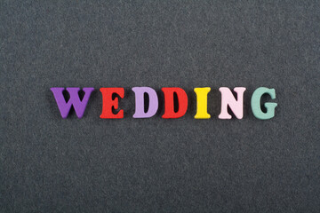 WEDDING word on black board background composed from colorful abc alphabet block wooden letters,...