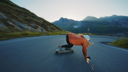 woman skateboarding and making tricks between the curves on a mountain pass. - 756679539