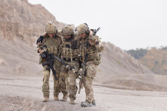 Soldier evacuated the injured fellow  from the mission in desert