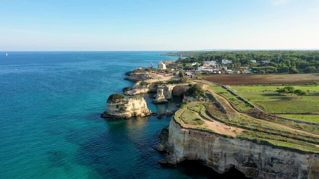Stunning seascape with cliffs rocky arch and stacks (Faraglioni) at Torre Sant Andrea, Salento coast, Puglia region, Italy. Beautiful cliffs and sea stacks of Sant'Andrea, Salento, Apulia, Italy