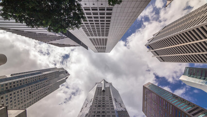 Looking up perspective of modern business skyscrapers glass and sky view landscape of commercial building in central city timelapse