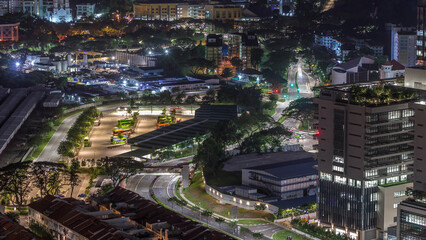 Aerial view to busy bus terminal in Singapore night timelapse.