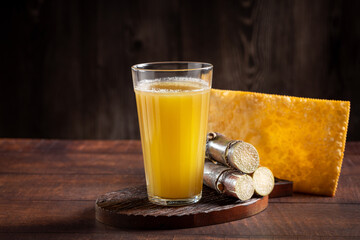 Glass of sugarcane juice with fried pastry. Typical Brazilian snack.