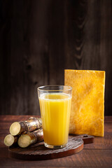 Glass of sugarcane juice with fried pastry. Typical Brazilian snack.