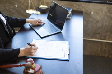 Fotobehang contract was placed on table inside legal counsel's office, ready for investors to sign the contract to hire a team of lawyers to provide legal advice for their investment. legal consulting concept © thatinchan