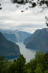 Nature view of Norwegian mountains from stegastein viewpoint on a cloudy summer day. Blue uv radiation on the mountains.